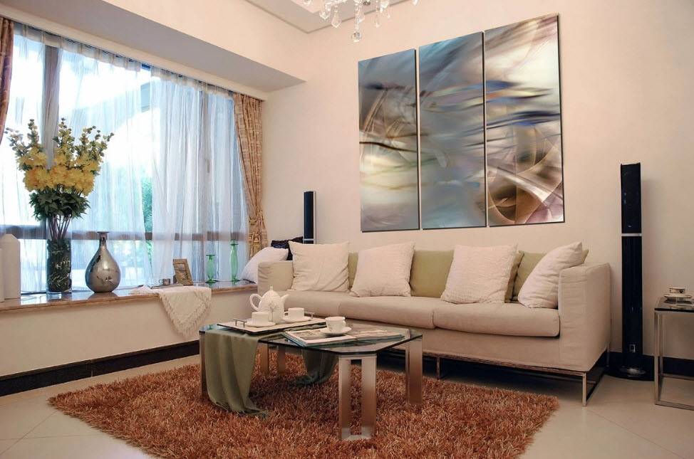 Оформление интерьера современной гостиной комнаты с помощью картин